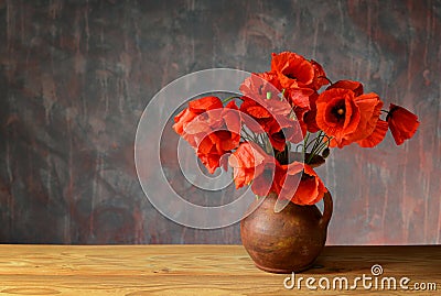 Red poppies in a ceramic vase Stock Photo