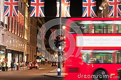 London flags and london bus by night Editorial Stock Photo