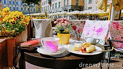 Street Cafe Tables chairs with cup of coffee Flowers City lifestyle Summer Day In Old Town Of Tallinn travel and tourism To Est Stock Photo