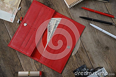 Red purse clutch purse, woman accessories and money on a white wooden table Stock Photo