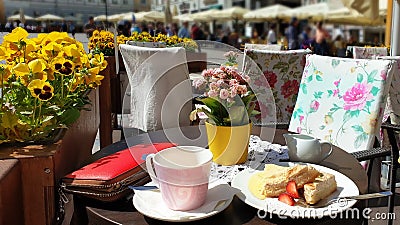 Street Cafe Tables chairs with cup of coffee Flowers City lifestyle Summer Day In Old Town Of Tallinn travel and tourism To Est Stock Photo