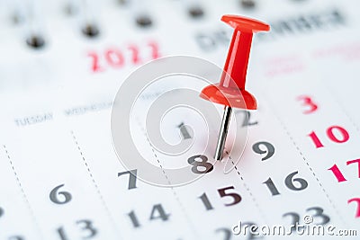 Red push pin on calendar 8th day of the month, mark the Event day with a Pin. Pin on calendar day eight, date number 8 Stock Photo