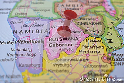 Red Push Pin Pointing Botswana on Location of World Map Close-Up View Stock Photo