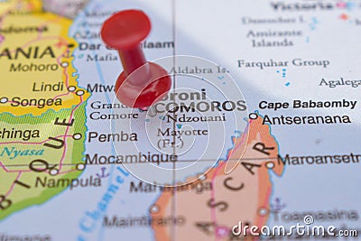 Red Push Pin Pointing Comoros on Location of World Map Close-Up View Stock Photo