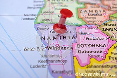 Red Push Pin Pointing Namibia on Location of World Map Close-Up View Stock Photo