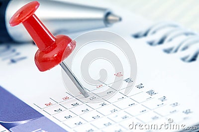 Red pushpin on calendar page for remind and marked important eve Stock Photo