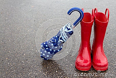Red rain boots and umbrella Stock Photo