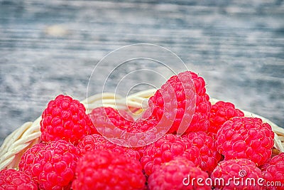 Red raspberries. Raspberry close-up on the table. Ripe red berry. Healthy and tasty food. Stock Photo