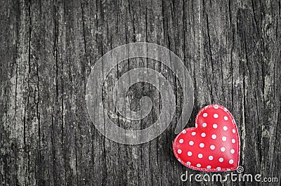Red retro heart with white polka dot pattern on wooden background with vintage and vignette tone Stock Photo