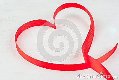 Red ribbon, lined in shape of heart Stock Photo