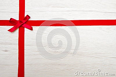 Red ribbon over wooden Stock Photo