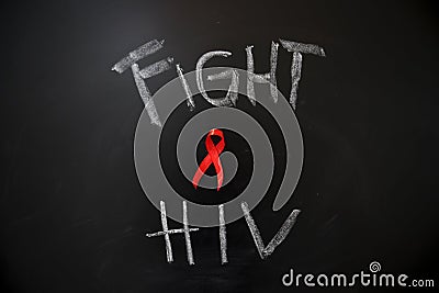 Red ribbon with text of fight HIV Stock Photo