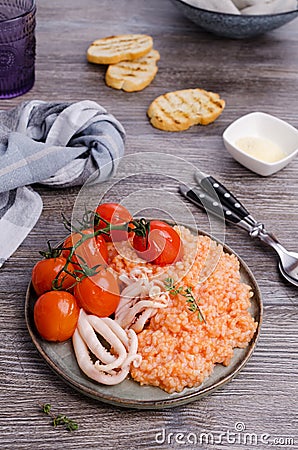 Red rice with seafood tentacles and tomatoes Stock Photo