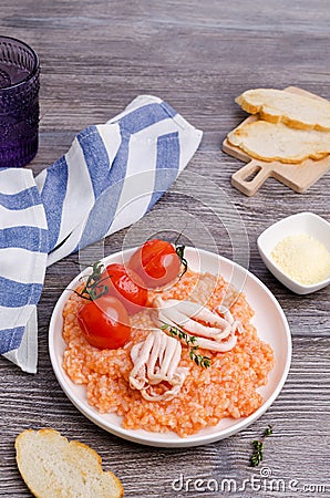 Red rice with seafood tentacles and tomatoes Stock Photo