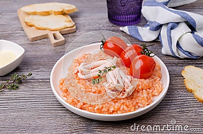 Red rice with seafood tentacles and tomatoes Stock Photo