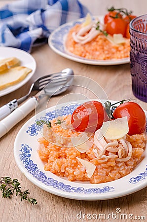 Red rice with seafood tentacles and tomatoes Stock Photo