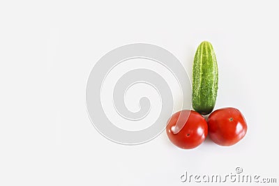 Red ripe juicy tomatoes and green cucumber. The phallic image of natural components. Stock Photo