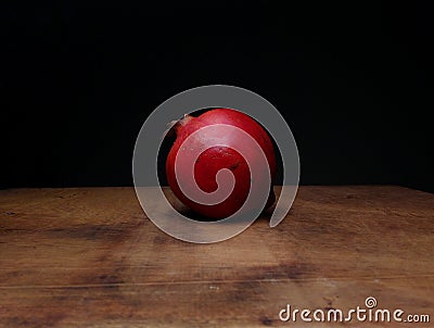 Red ripe pomegranate on a table wooden Stock Photo