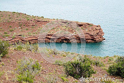 Red rocks shore of the lake Stock Photo