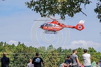 Red Romanian emergency services helicopter at Iasi rally event in the sky Editorial Stock Photo