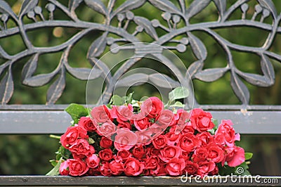 The red rose on the chair symbolizes eternal love. Stock Photo