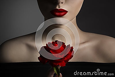 Red Rose Flower and Model Lips Close up Fine Art Portrait. Beauty Model Face and Shoulders Make up. Elegant Mysterious Lady Stock Photo