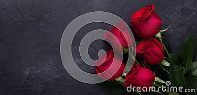 Red rose flowers bouquet on black stone background Valentine`s day greeting card Copy space Horizontal banner Stock Photo