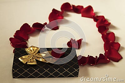 Red rose petals heart and gift Stock Photo