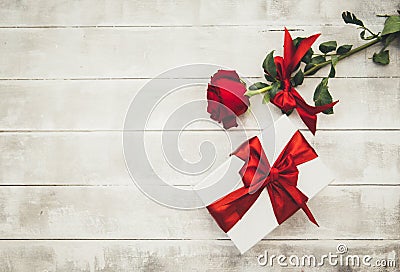 Red roses and gift box on a wooden table. Happy Valentines Day Stock Photo