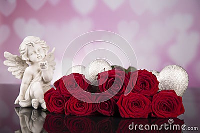 Red roses and gray wicker hearts and angel for valentine`s day Stock Photo