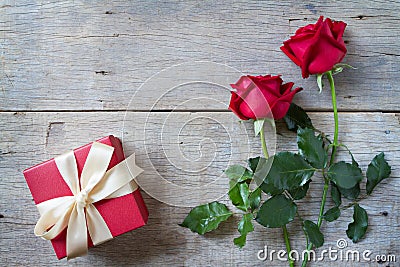 Red roses with red gift box on woonden background. Valentine's day , anniversary etc background. Stock Photo