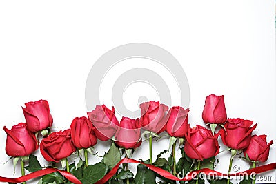 Red roses with ribbon on white background. Valentine's Day, anniversary and congratulations background. Stock Photo