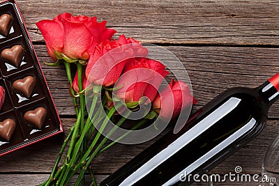 Red roses, wine bottle and chocolate box Stock Photo