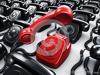 Red rotary phone surrounded by black phones Stock Photo
