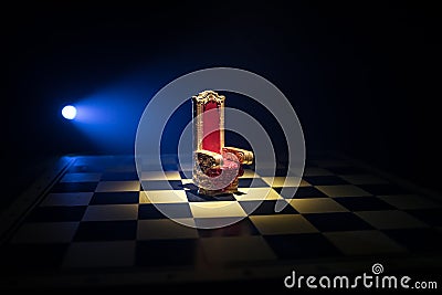 Red royal chair miniature on wooden table. Medieval Throne on chessboard. Chess board game concept of business ideas and Stock Photo