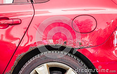 Red rusted and scratched car with damaged rusty paint in crash accident or parking lot Stock Photo