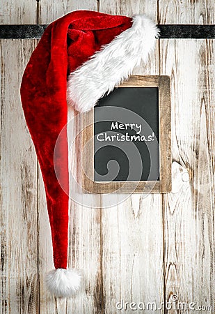 Red Santa hat and vintage chalkboard. Christmas decoration Stock Photo