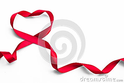 Red satin ribbon bow in heart shape isolated on white background clipping path, symbolic concept for National heart month Stock Photo