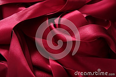 Red satin ribbons in a messy mess texture Stock Photo