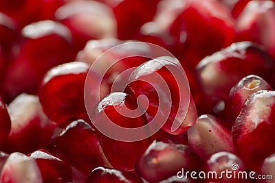 Red shiny pomegranate seeds on white background tasty and organic fruit peeled Stock Photo