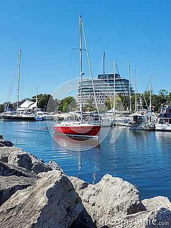 A red ship start sailing on the lake. Editorial Stock Photo