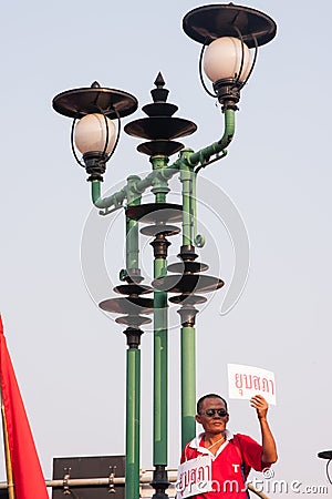 Red shirt man raises a paper with the word mean dissolve the par Editorial Stock Photo