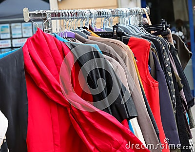 red shirt with scarf and other clothes for sale in used and new clothes stall Stock Photo