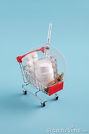 Red shopping cart with medicinal pills and tablets closeup Stock Photo