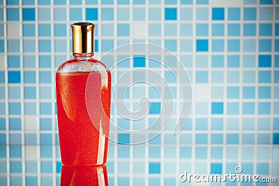 Red shower gel on blue tile background Stock Photo
