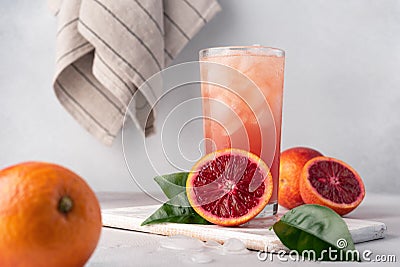 Red Sicilian orange juice in a glass and fresh oranges Stock Photo