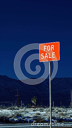 Red signpost with the words For sale against the night landscape backdrop. For sale button concept. Generative AI Stock Photo