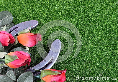 Red silk roses, a horseshoe and artificial green grass for the running of the thoroughbred race called the Kentucky Derby. Stock Photo