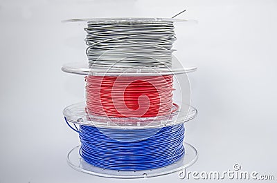 Red, silver and blue plastic filament coils for 3d Stock Photo