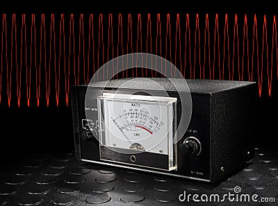 REd sine wave behind a two way radio watt meter Stock Photo